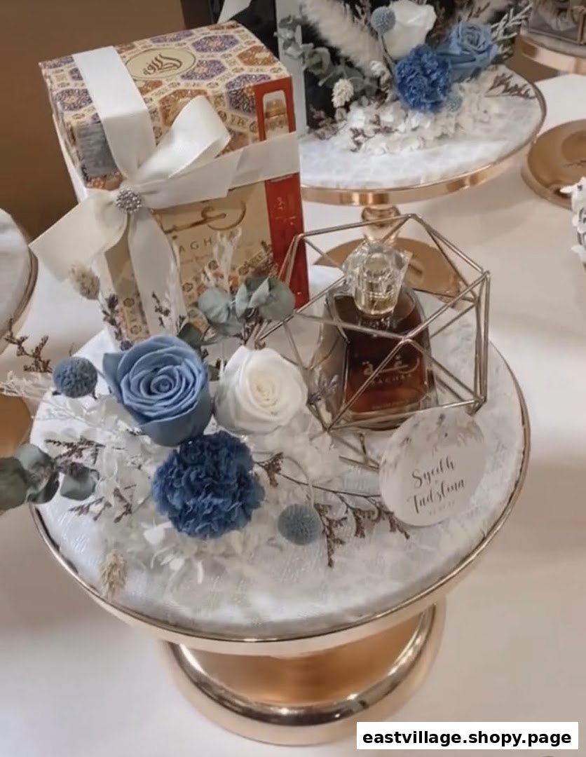An elegant gift set featuring a perfume bottle, blue and white floral arrangements, and a decorative gift box.