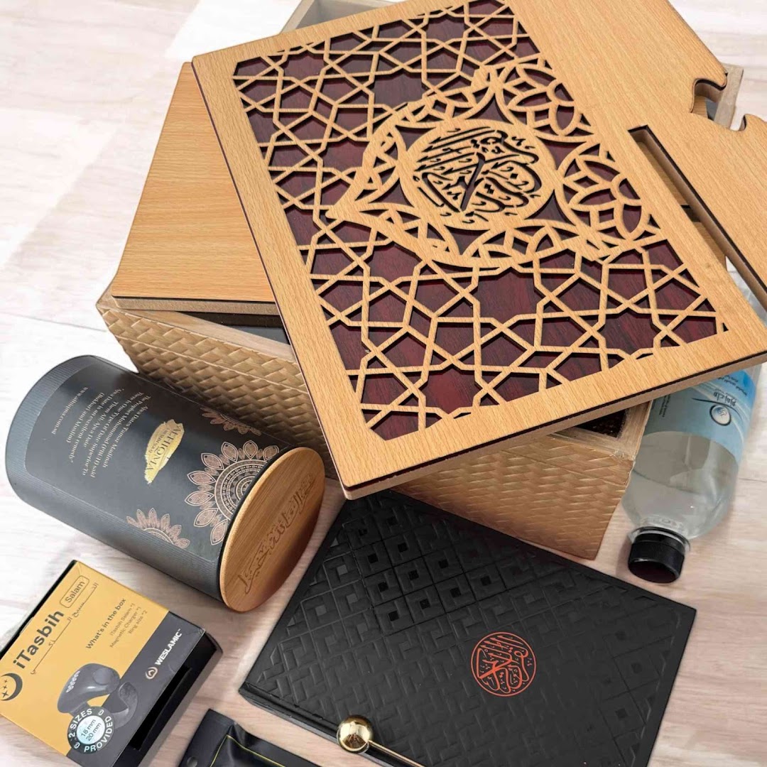A collection of elegant Islamic gift items, including a wooden Quran box, date container, and iTasbih.