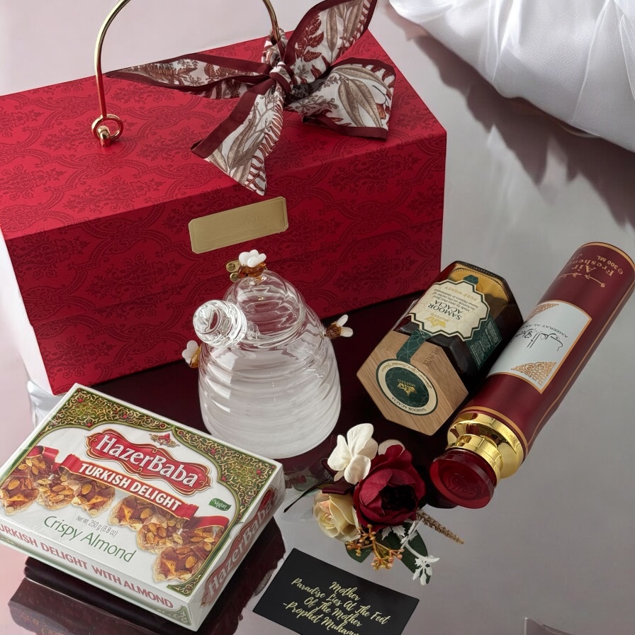 A curated collection of Islamic gifts including Turkish delight, honey, and air freshener, presented in a red gift box.