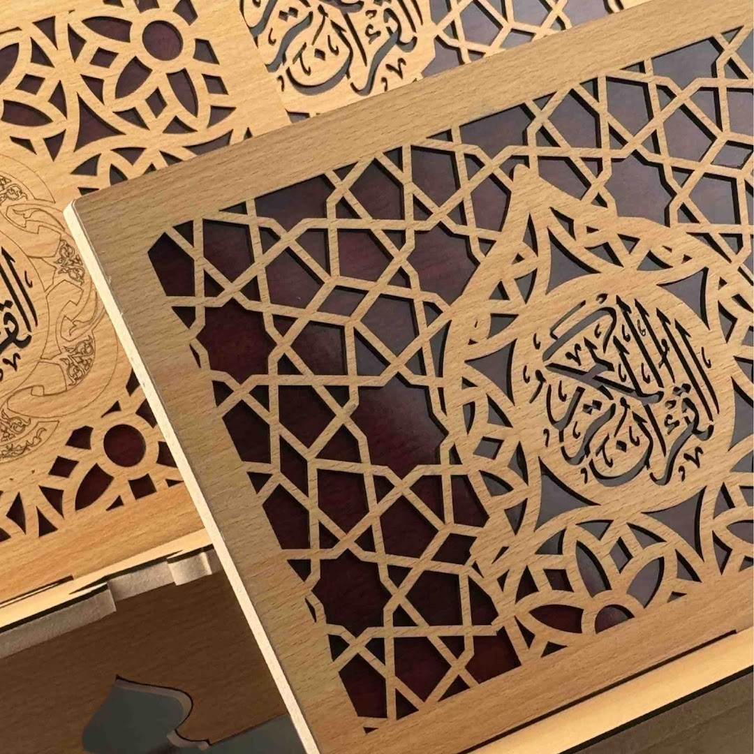 Close-up of a beautifully crafted wooden box featuring intricate Islamic geometric patterns and calligraphy.