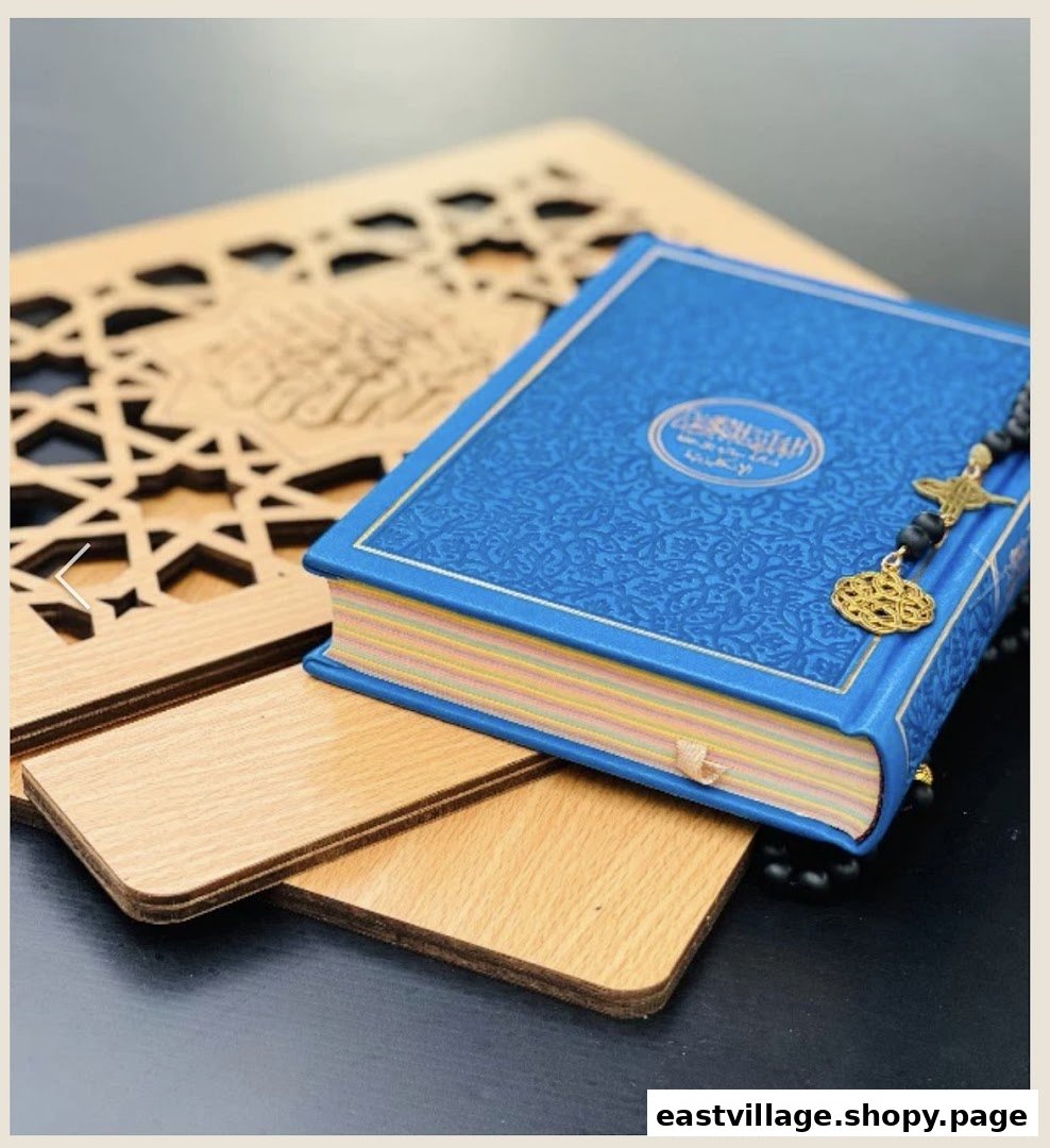 A blue Quran with prayer beads and a wooden stand featuring Islamic patterns.