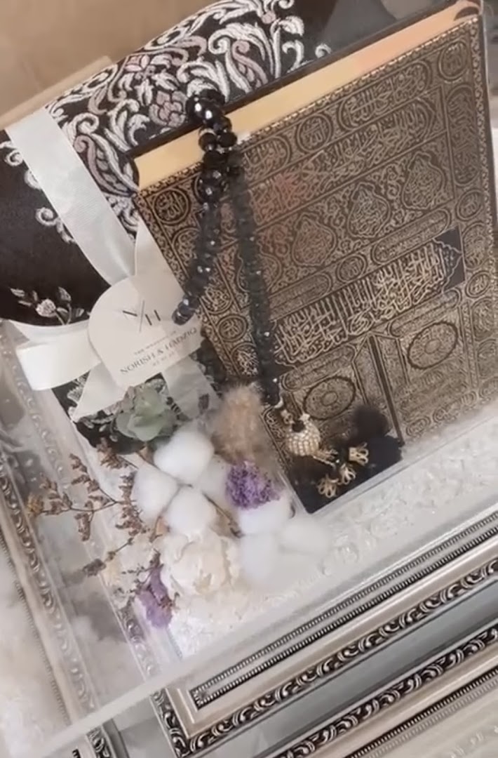 A beautifully presented Islamic gift set featuring a prayer mat, Quran, and prayer beads in an elegant box.
