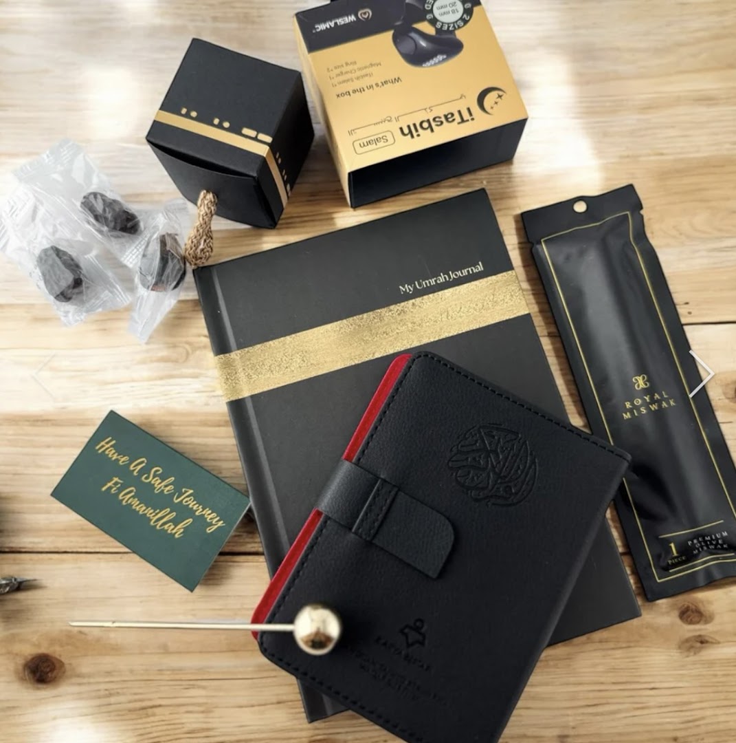 A flat lay of Islamic gift items including a journal, digital tasbih, miswak, and dates.