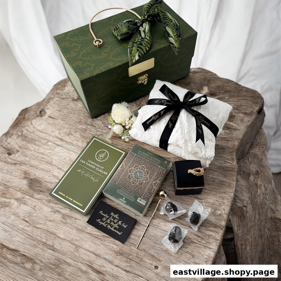 A curated collection of Islamic gifts, including a Quran, prayer mat, and dates, presented in a decorative box.