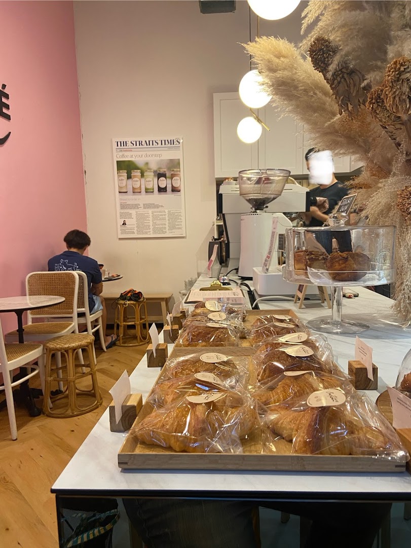 Interior view of Café Cartisan, showcasing a display of fresh pastries and the coffee preparation area.
