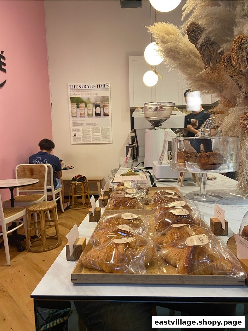 Interior view of Café Cartisan, showcasing a display of fresh pastries and the coffee preparation area.