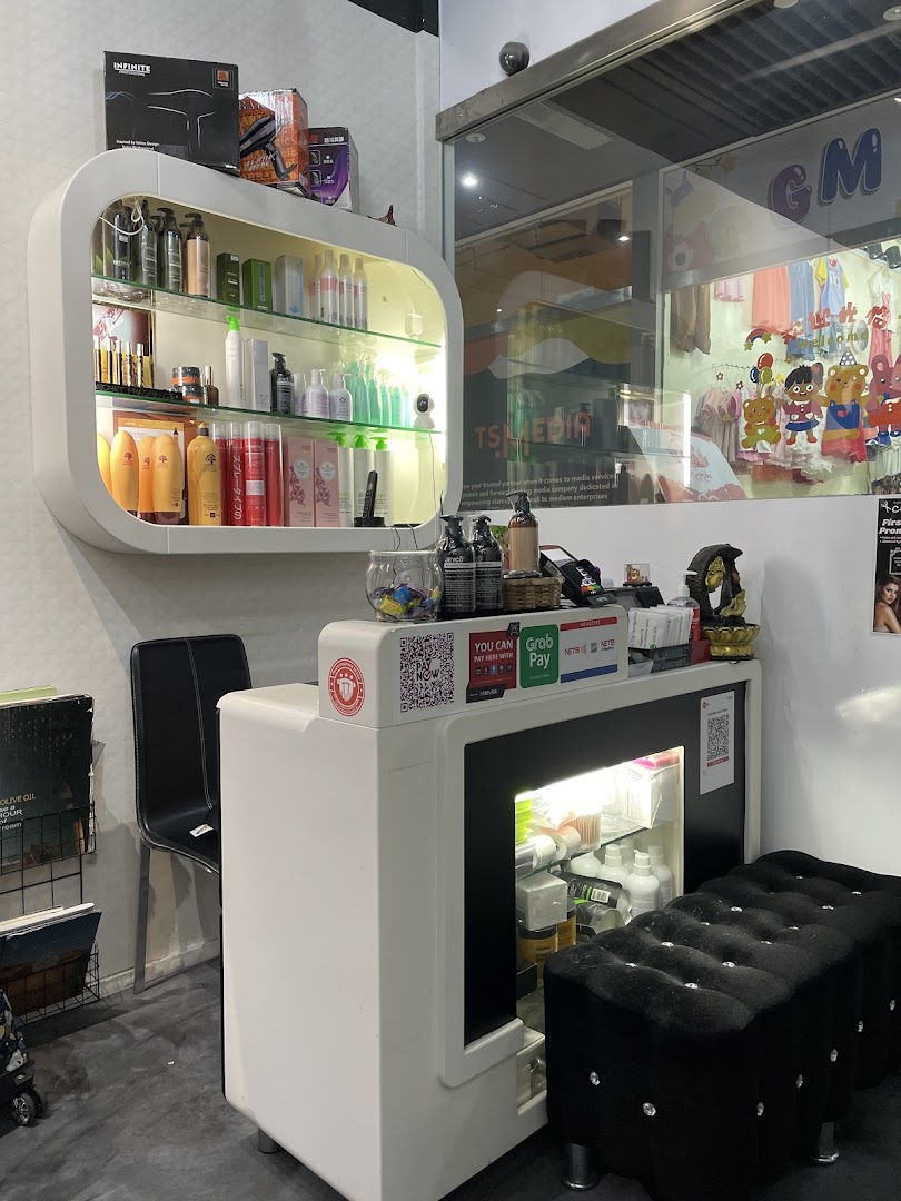 Interior view of Charisma Hair Studio showing product display, reception counter, and waiting area.