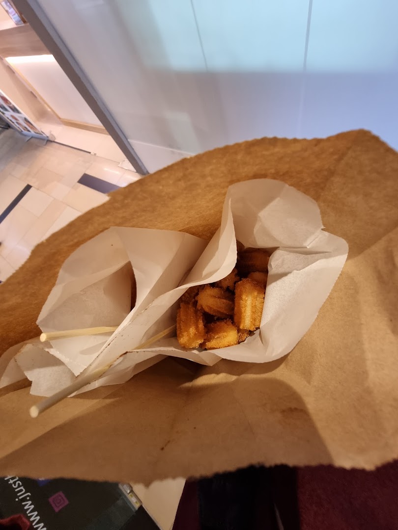 Golden churros served in a paper bag, ready to enjoy from Chulop! by The Syarifs.
