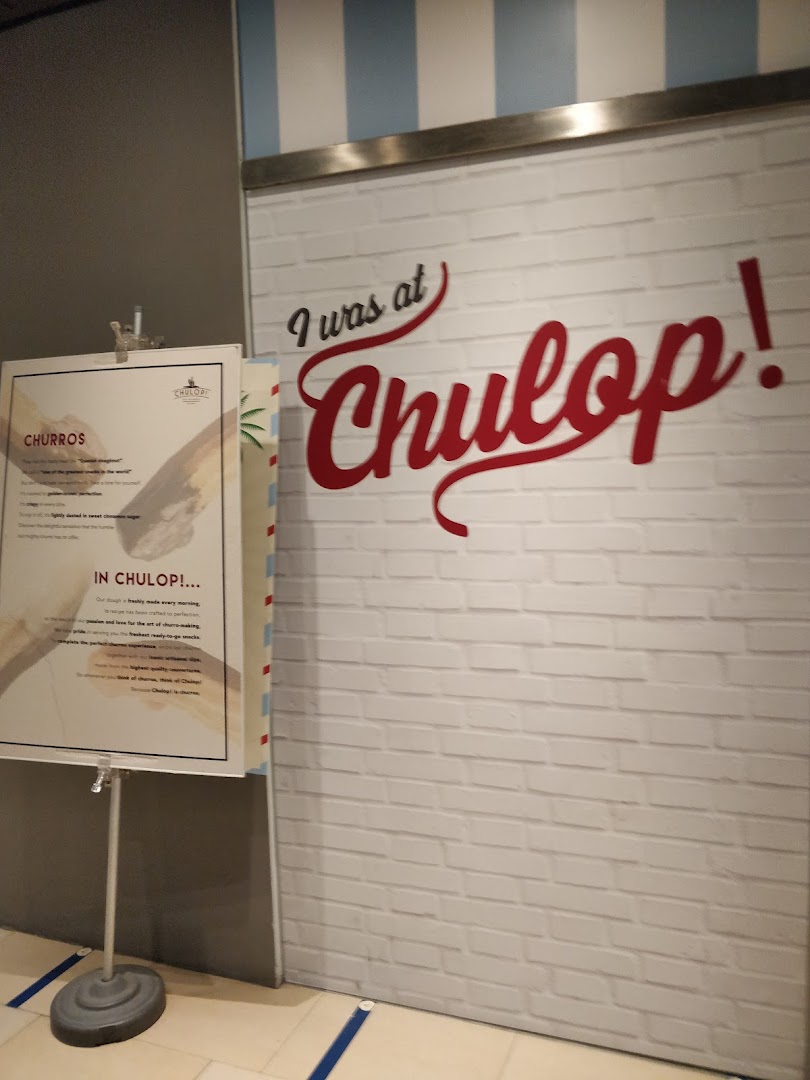 Entrance to Chulop! by The Syarifs featuring a 'I was at Chulop!' sign and a churros information standee.