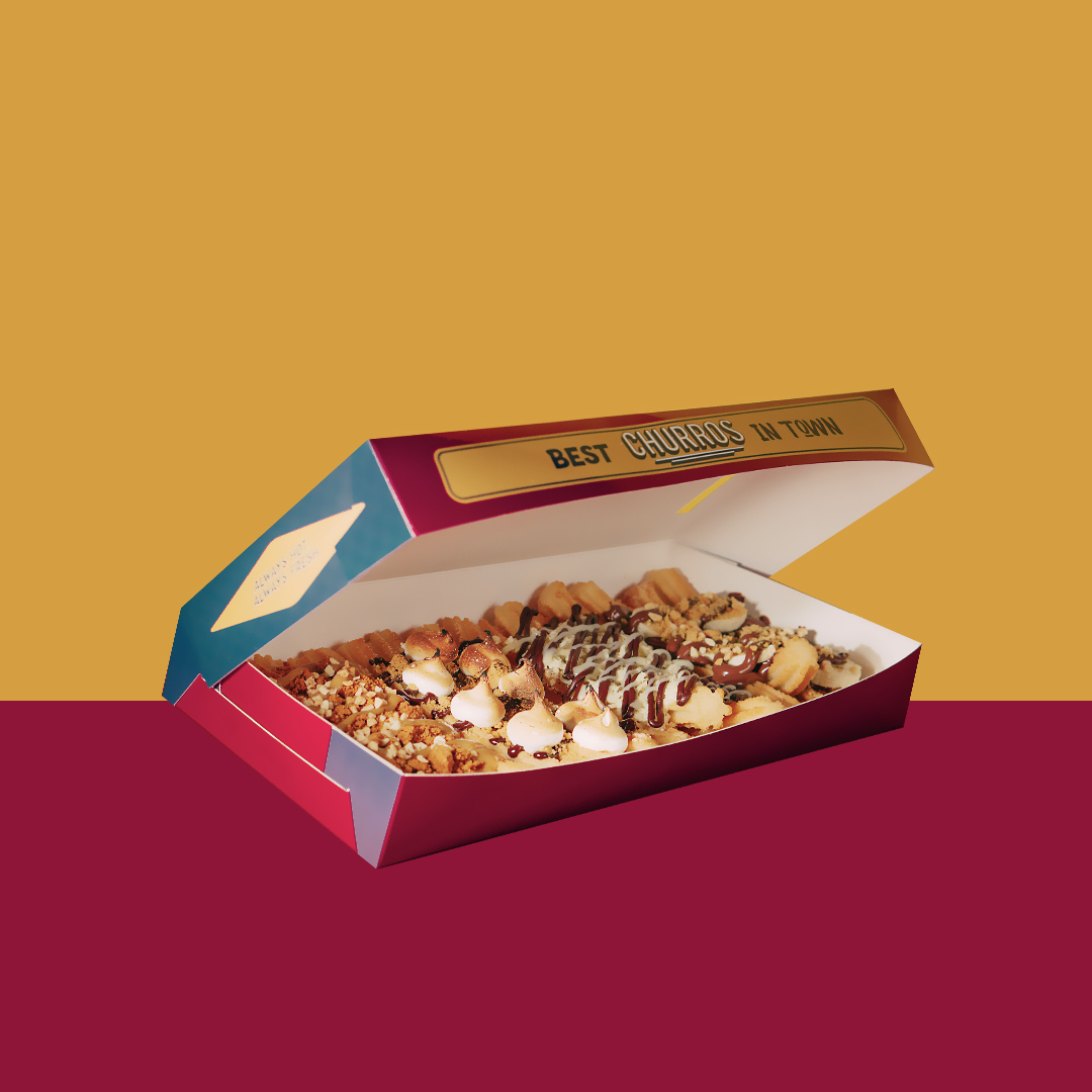 A vibrant image showcasing a box of delicious churros with various toppings, ready to be enjoyed.