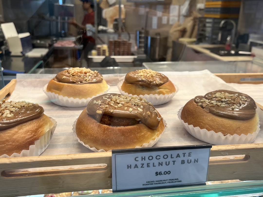 Delicious chocolate hazelnut buns displayed in a bakery case with a visible price tag.