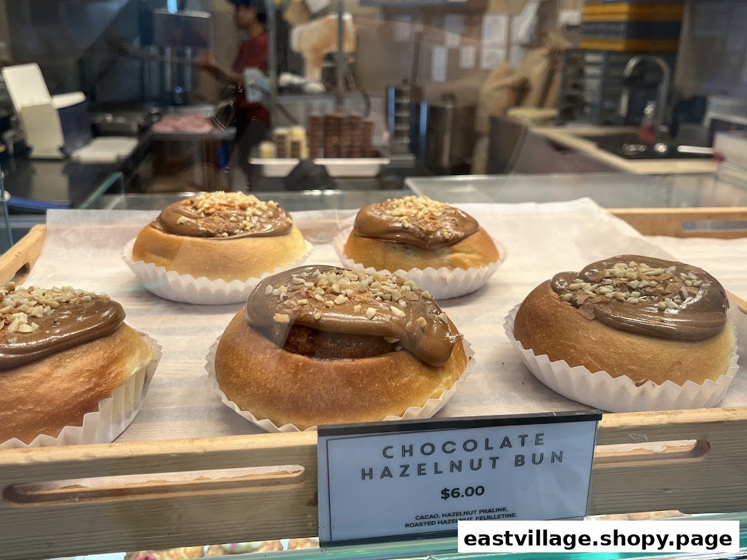 Delicious chocolate hazelnut buns displayed in a bakery case with a visible price tag.