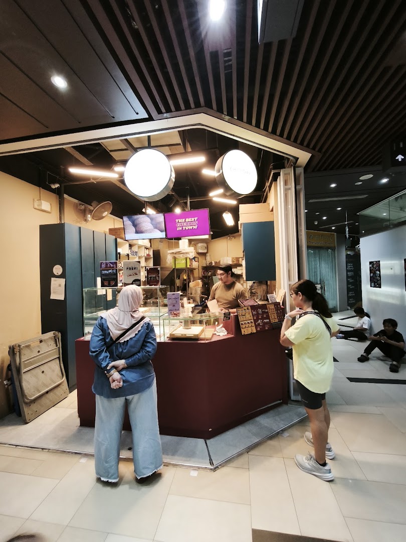 Customers at the counter of Chulop! by The Syarifs, a dessert shop specializing in churros.