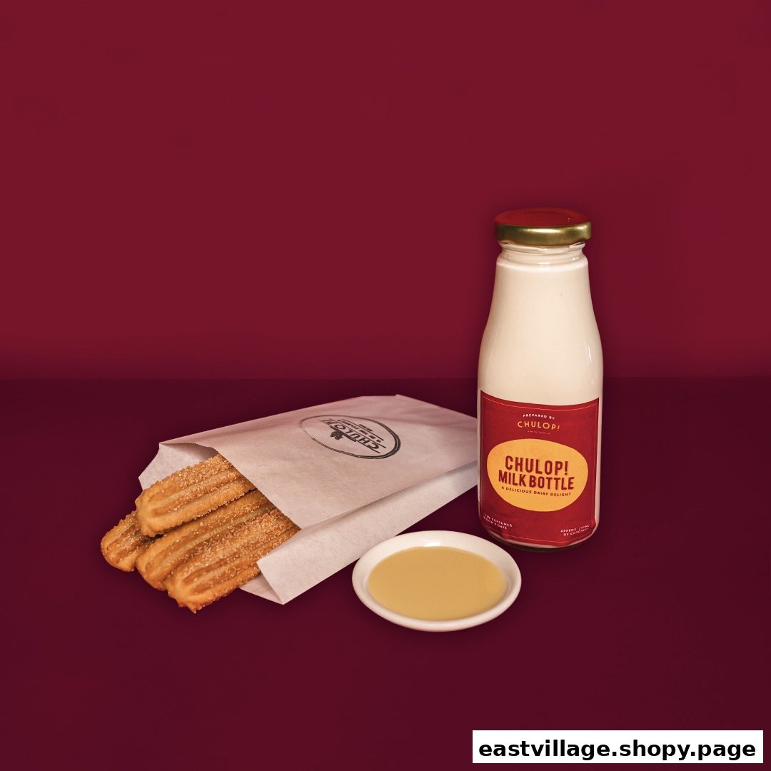 A paper bag of churros with a dipping sauce and a Chulop! Milk Bottle on a red background.
