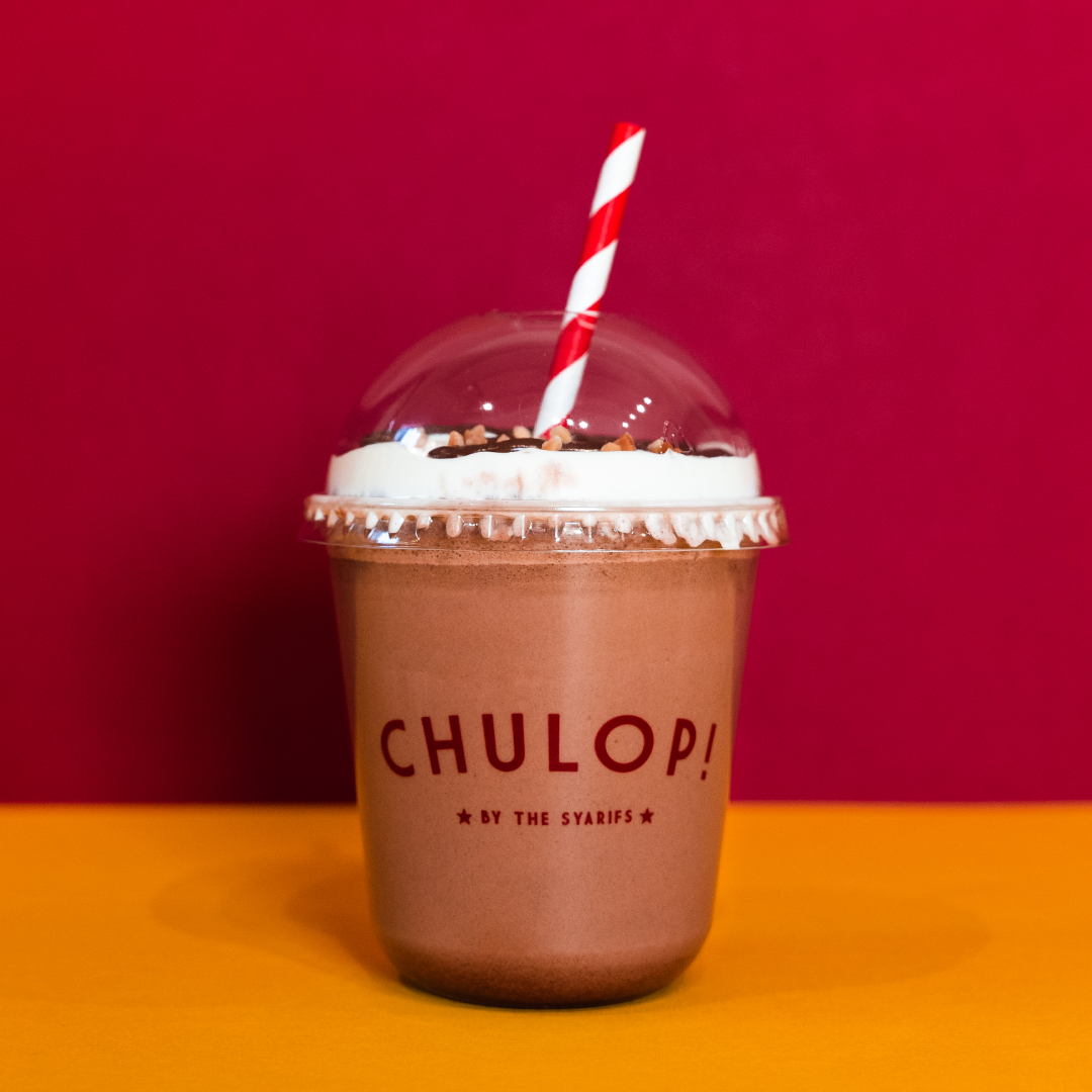 A delicious chocolate drink from Chulop! by The Syarifs, topped with whipped cream and nuts.