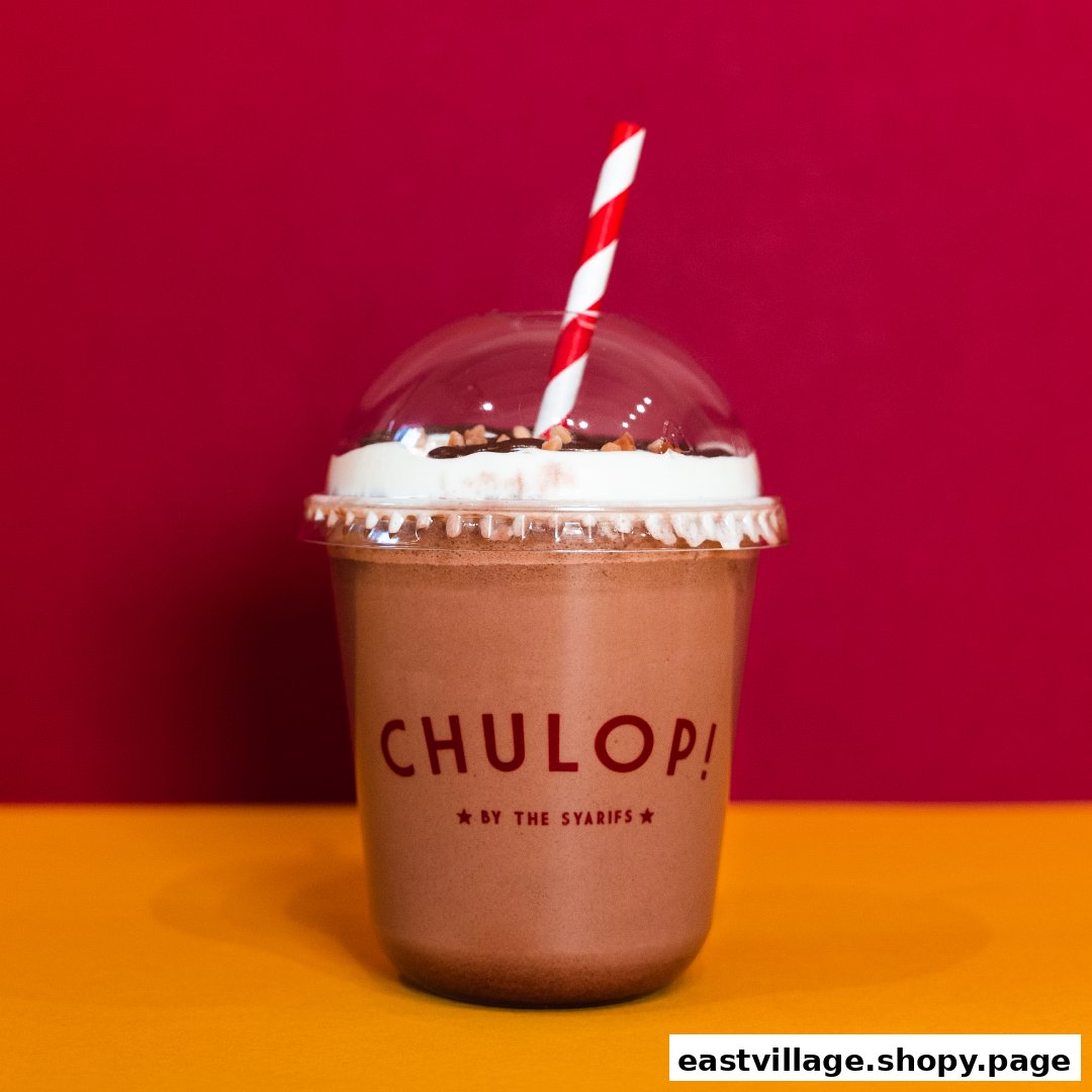 A delicious chocolate drink from Chulop! by The Syarifs, topped with whipped cream and nuts.