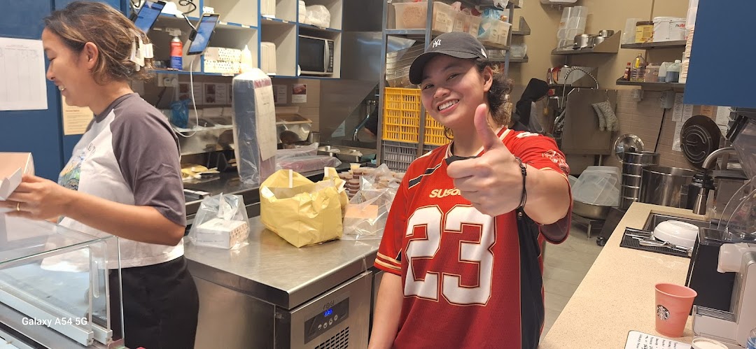 Two friendly staff members are seen working in the kitchen area of Chulop! by The Syarifs.