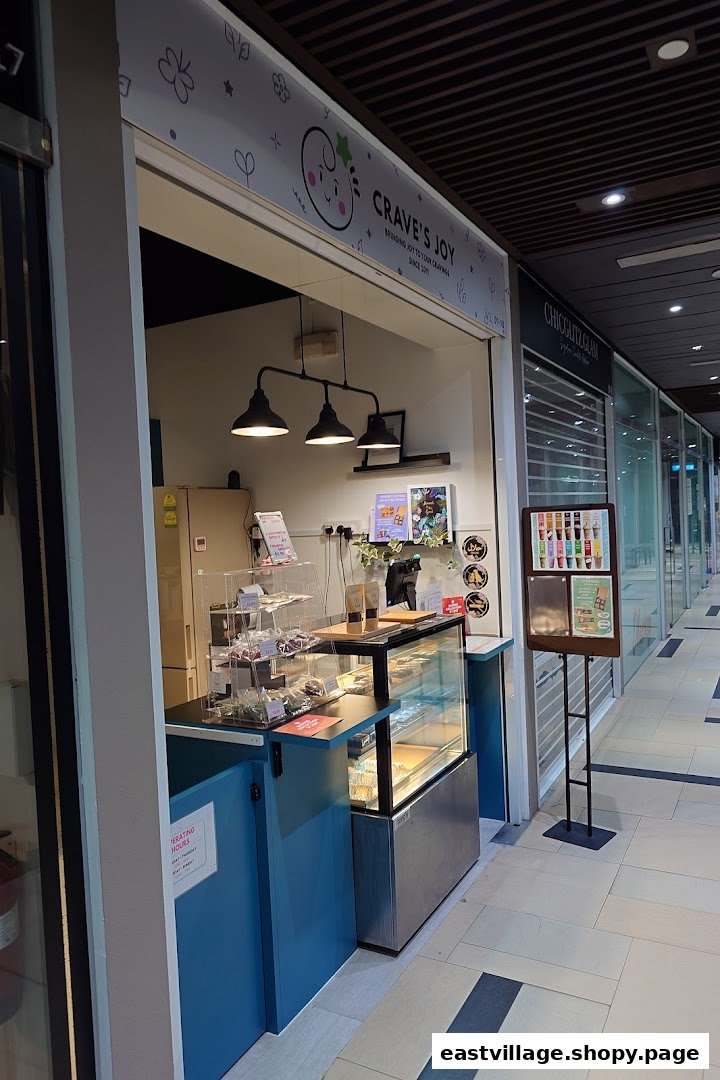 The image shows the inviting storefront of Craves Joy, a dessert and snack shop, within a mall corridor.