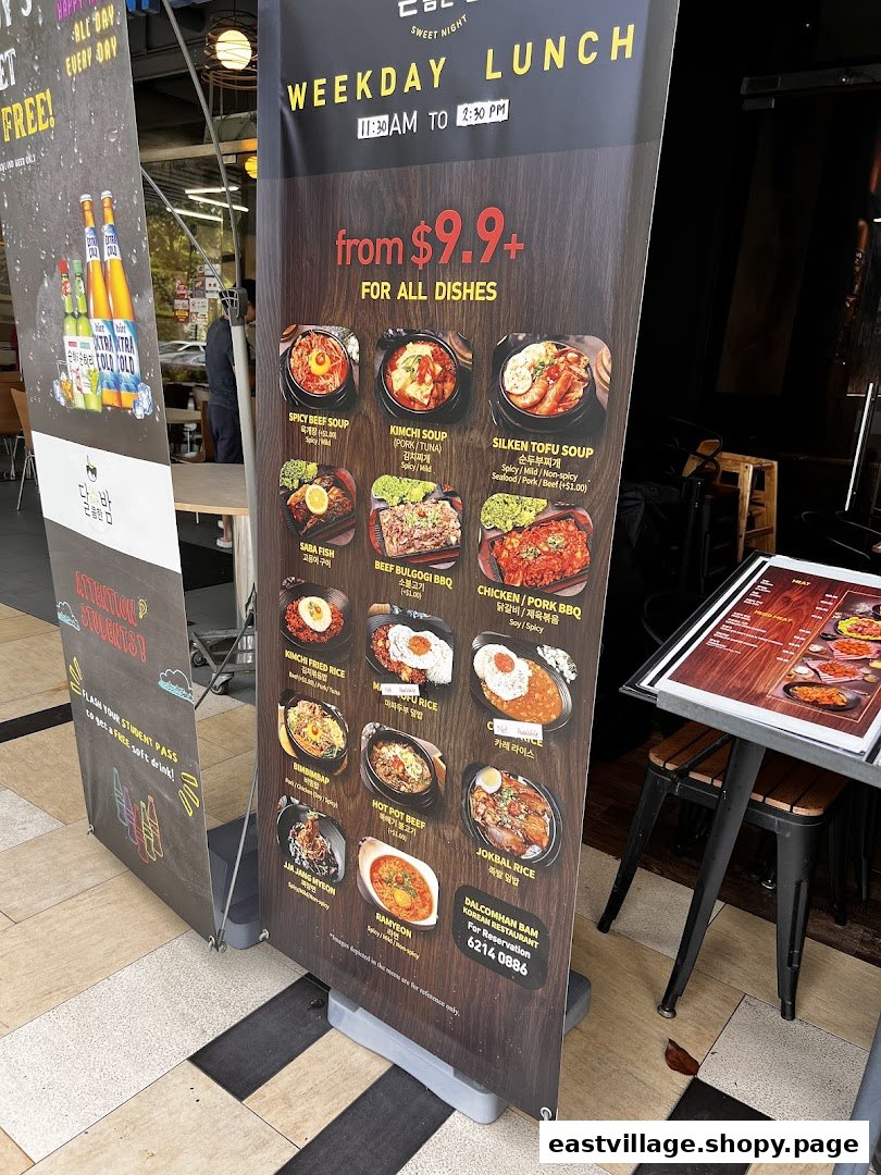 A standee displaying the weekday lunch menu and special offers for Dalcomhan Bam Korean Restaurant.