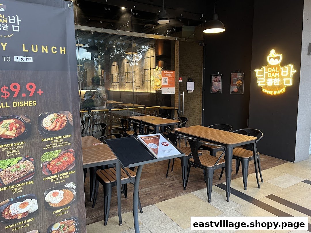 Exterior view of Dalcomhan Bam Korean Restaurant featuring a prominent lunch menu banner and outdoor seating.
