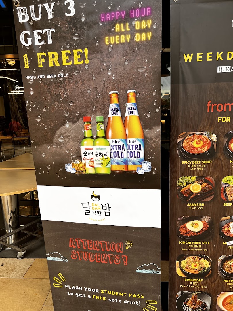 A promotional standee displaying drink specials, student discounts, and a partial menu for a Korean restaurant.