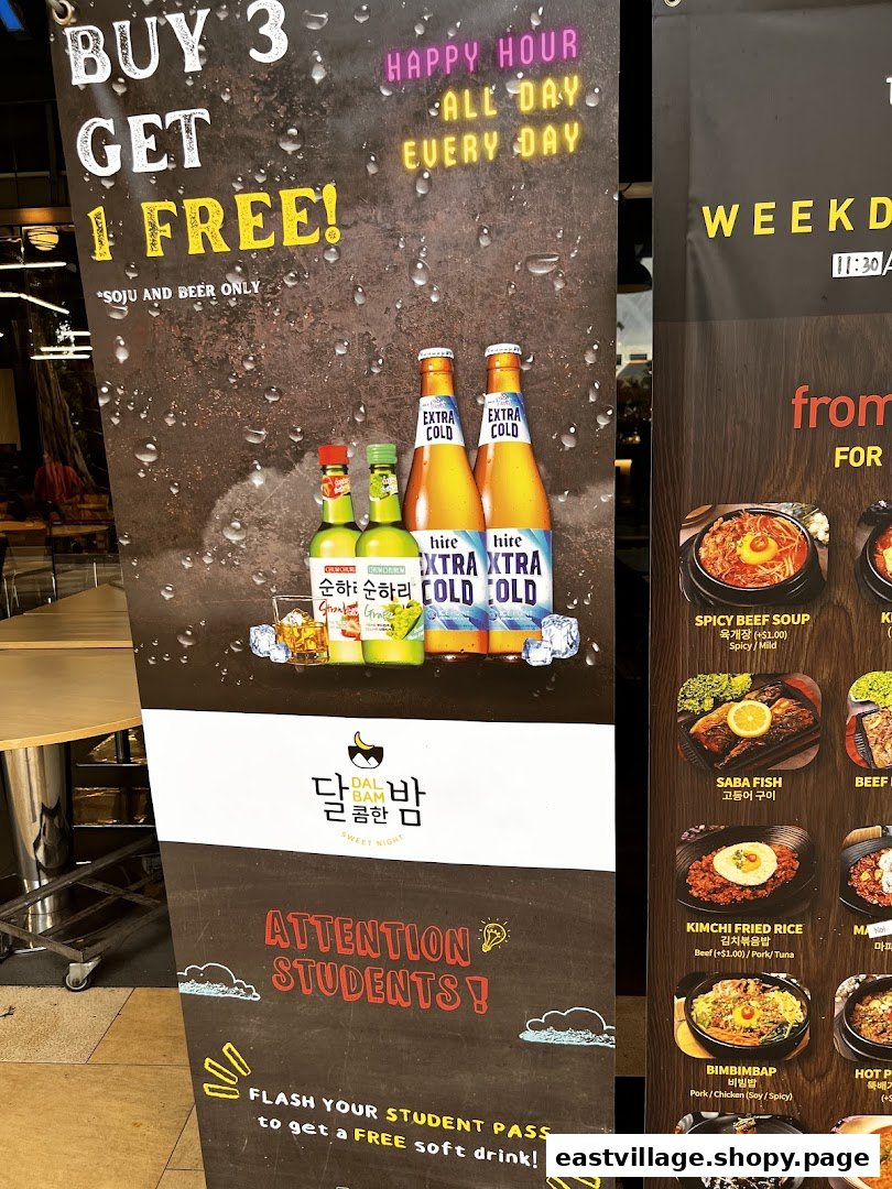 A promotional standee displaying drink specials, student discounts, and a partial menu for a Korean restaurant.