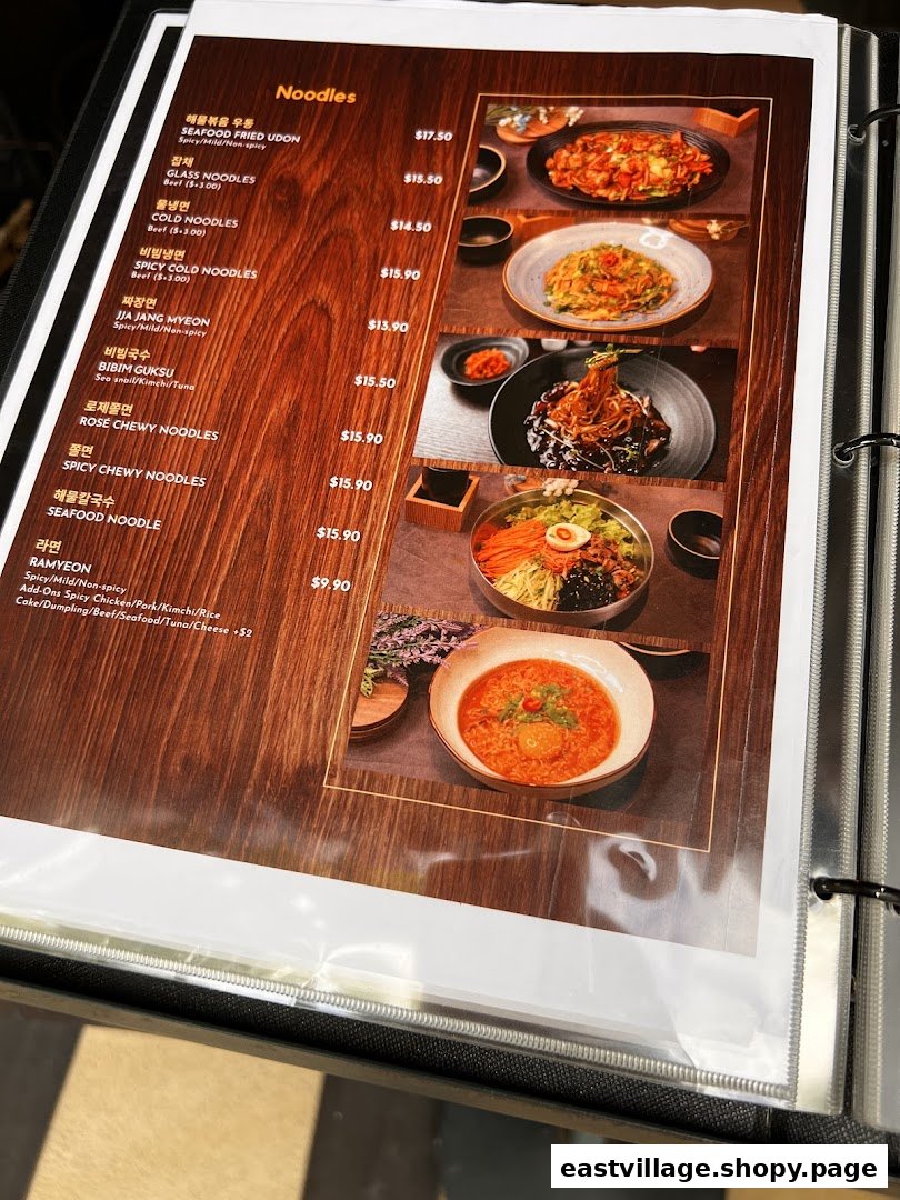 A menu page displaying various Korean noodle dishes with prices and descriptions.