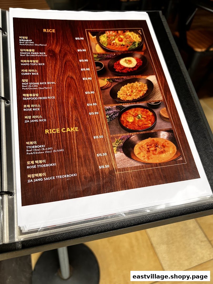 A detailed view of a Korean restaurant's menu featuring rice and rice cake dishes.