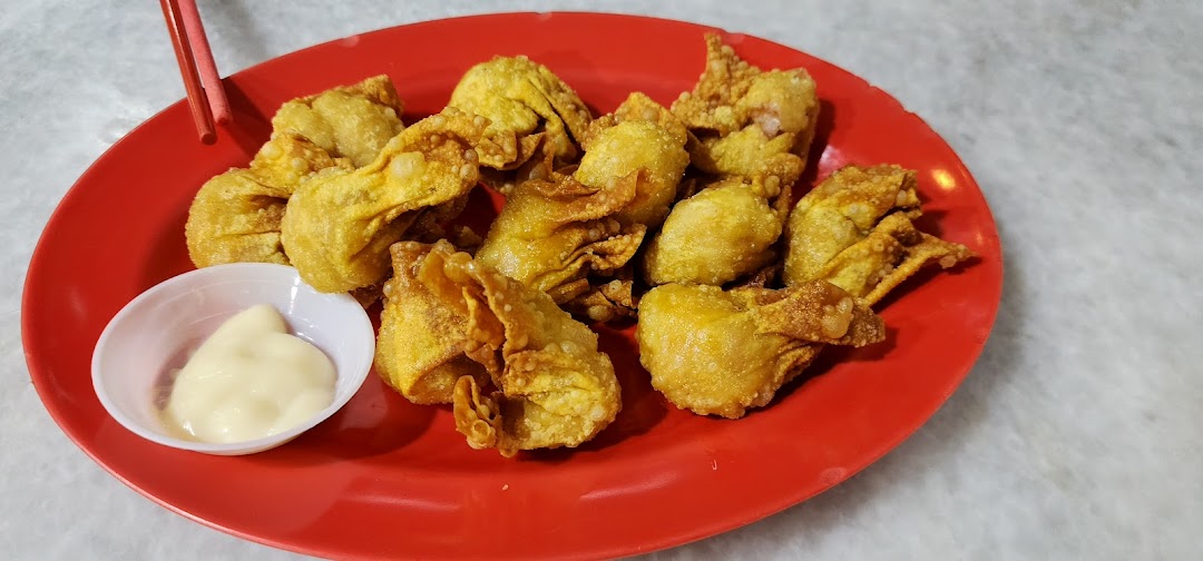 A plate of crispy fried wontons with a side of creamy mayonnaise, ready to be enjoyed.