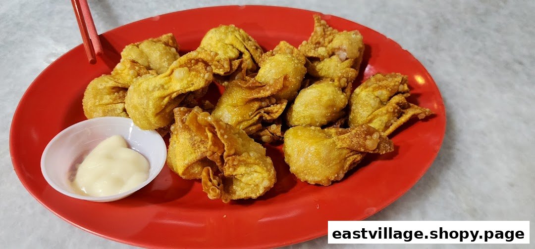 A plate of crispy fried wontons with a side of creamy mayonnaise, ready to be enjoyed.