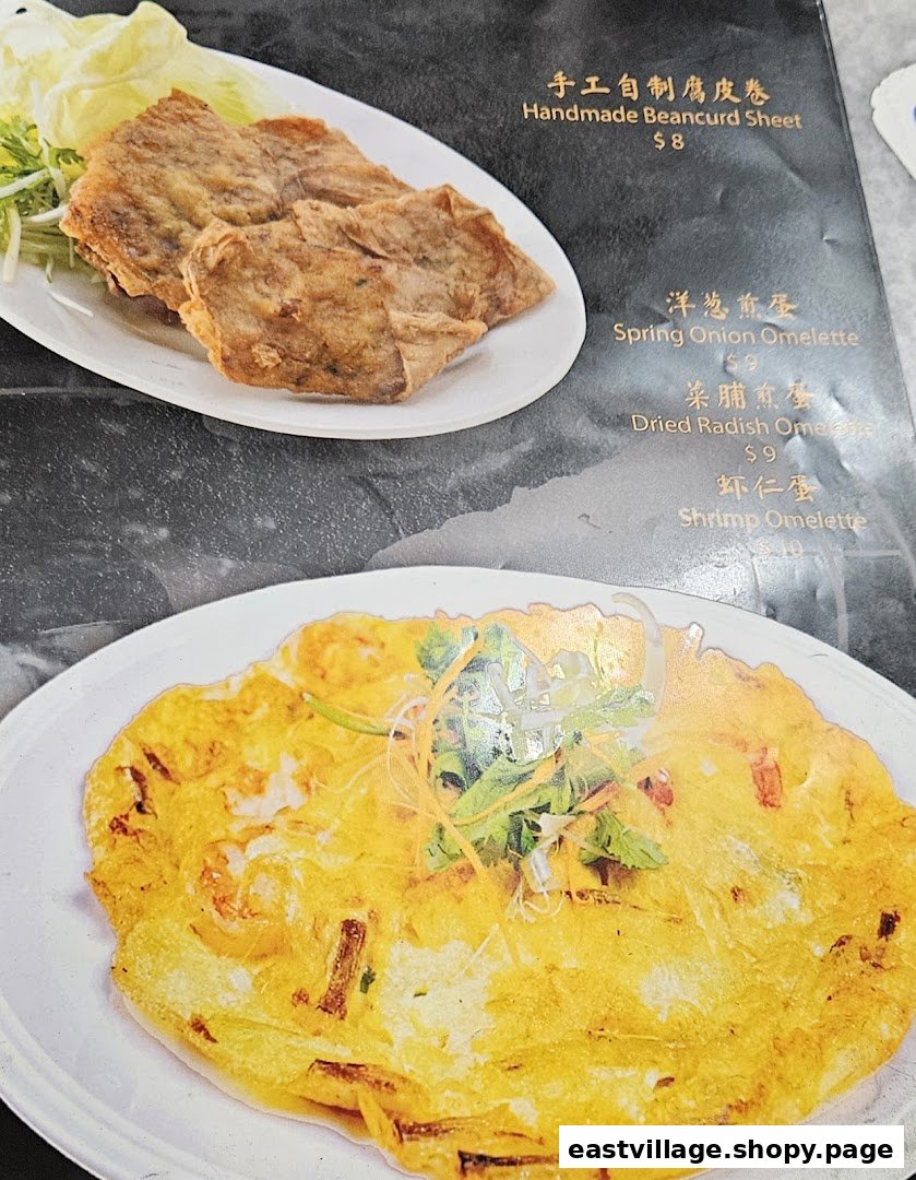 A menu page displaying two dishes: Handmade Beancurd Sheet and a Shrimp Omelette, with other omelette options listed.