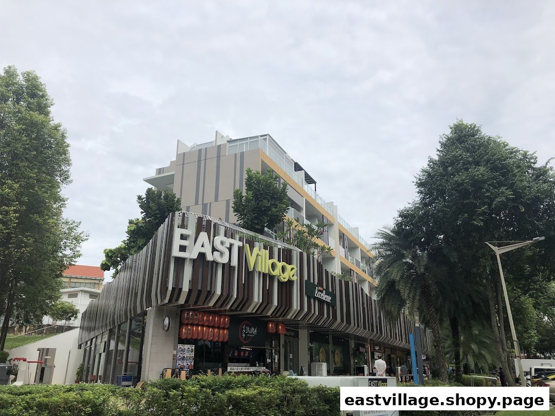 Exterior view of the modern East Village complex, showcasing its distinctive architecture and various shopfronts.