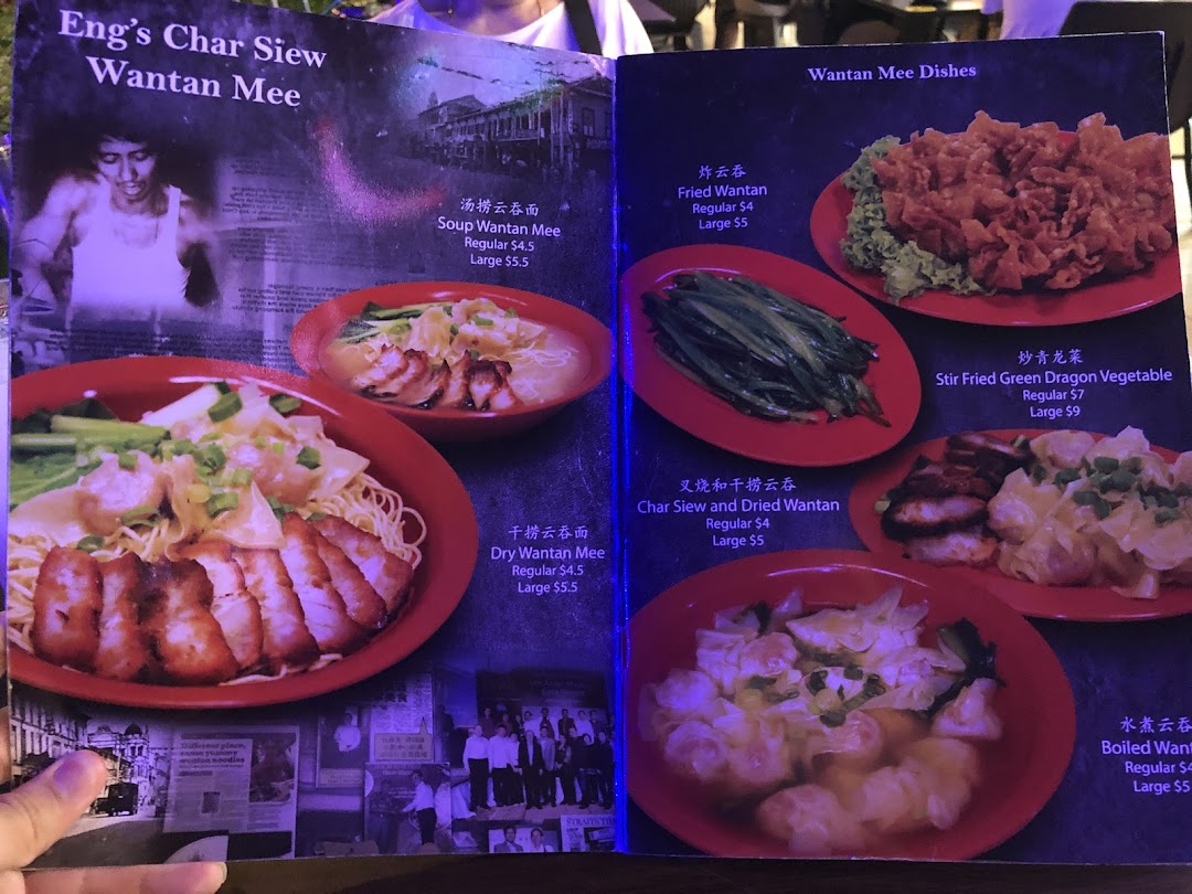 A vibrant menu displaying various Wantan Mee dishes and sides with prices.
