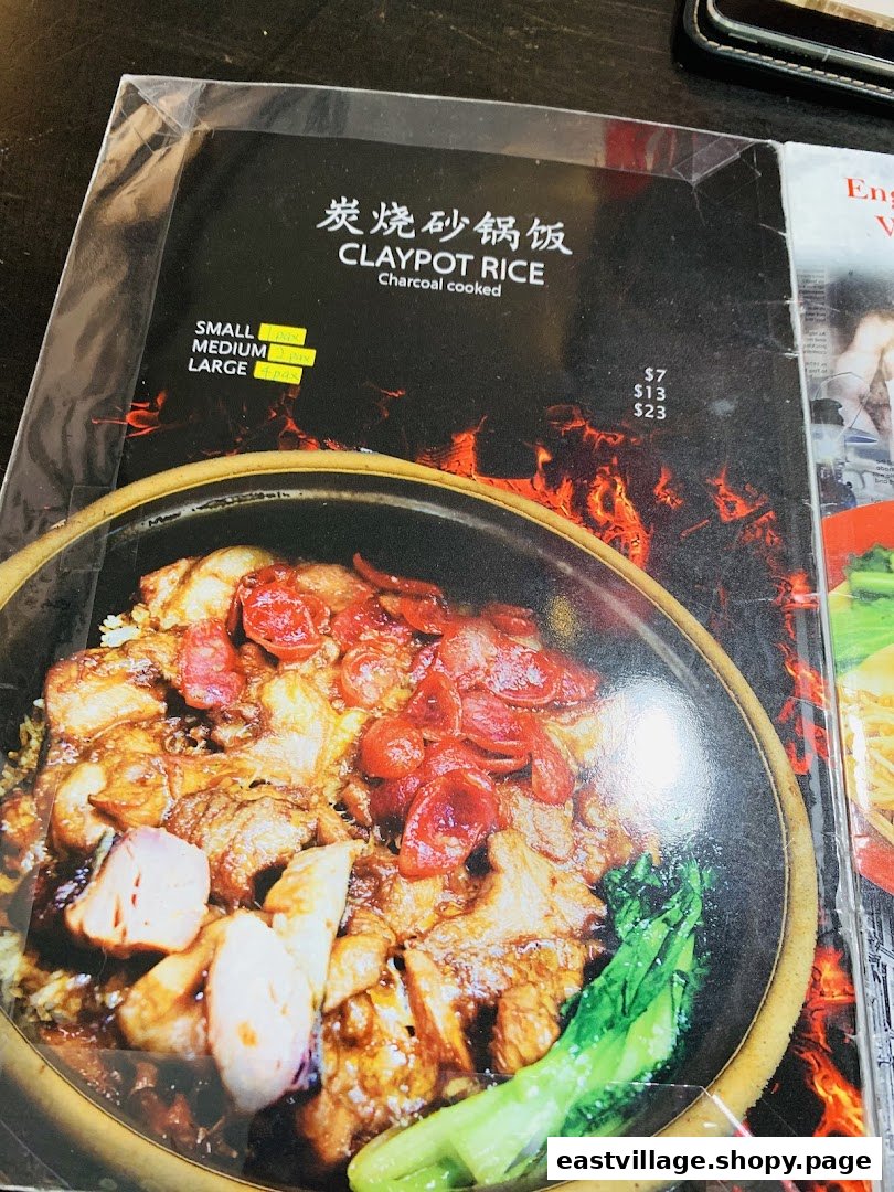 A menu page displaying charcoal-cooked Claypot Rice with size and price options.