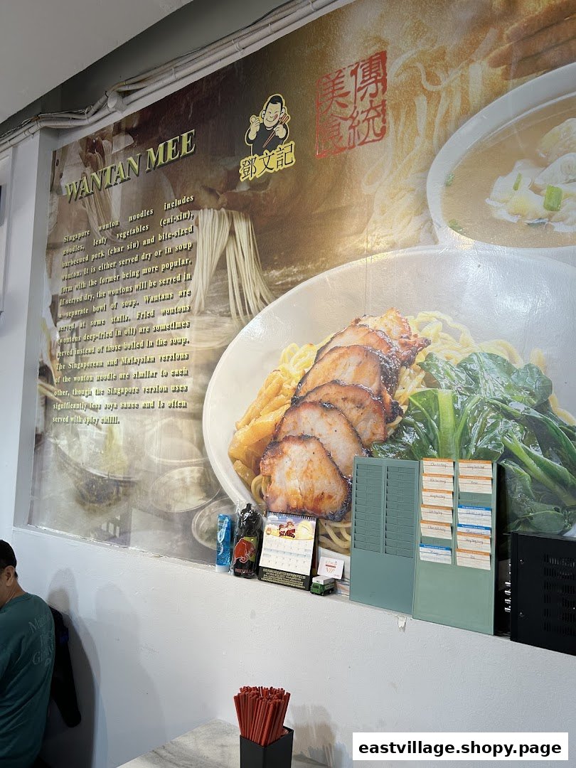 A large wall graphic inside Deng Wen Ji - East Village, featuring a detailed description and image of their signature Wantan Mee.