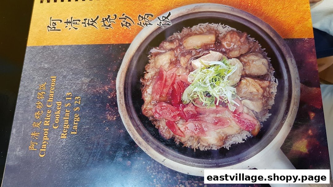 A close-up of a menu page featuring a delicious claypot rice dish with pricing.