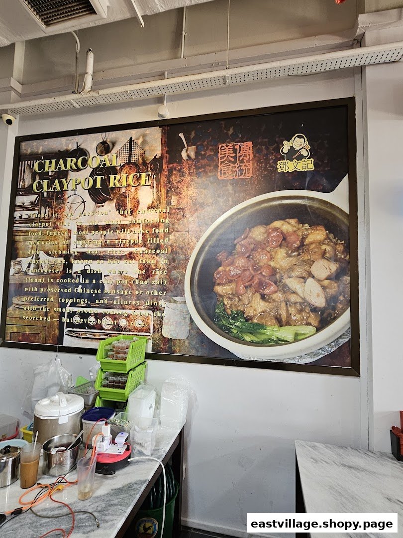 A large promotional poster inside Deng Wen Ji showcasing their signature Charcoal Claypot Rice.