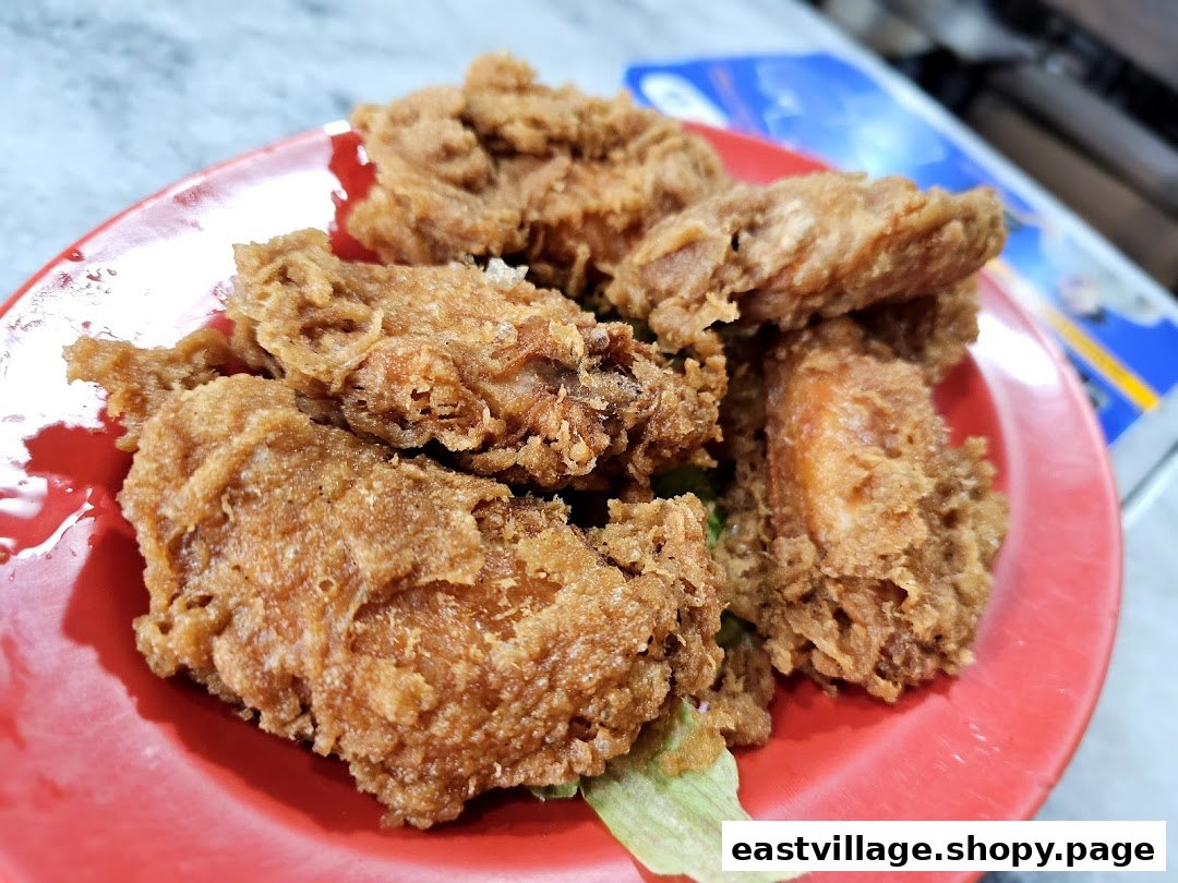 A close-up shot of crispy golden-brown fried chicken pieces served on a vibrant red plate.