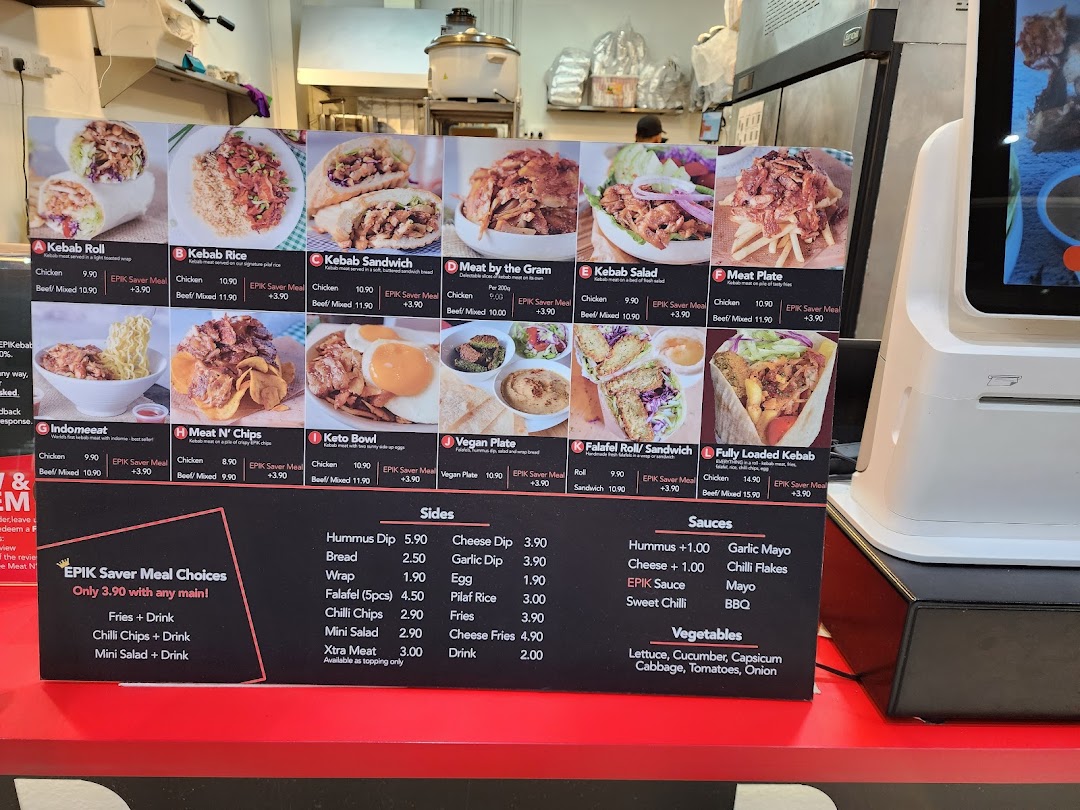 A vibrant menu board displaying various kebab dishes with prices and meal options.
