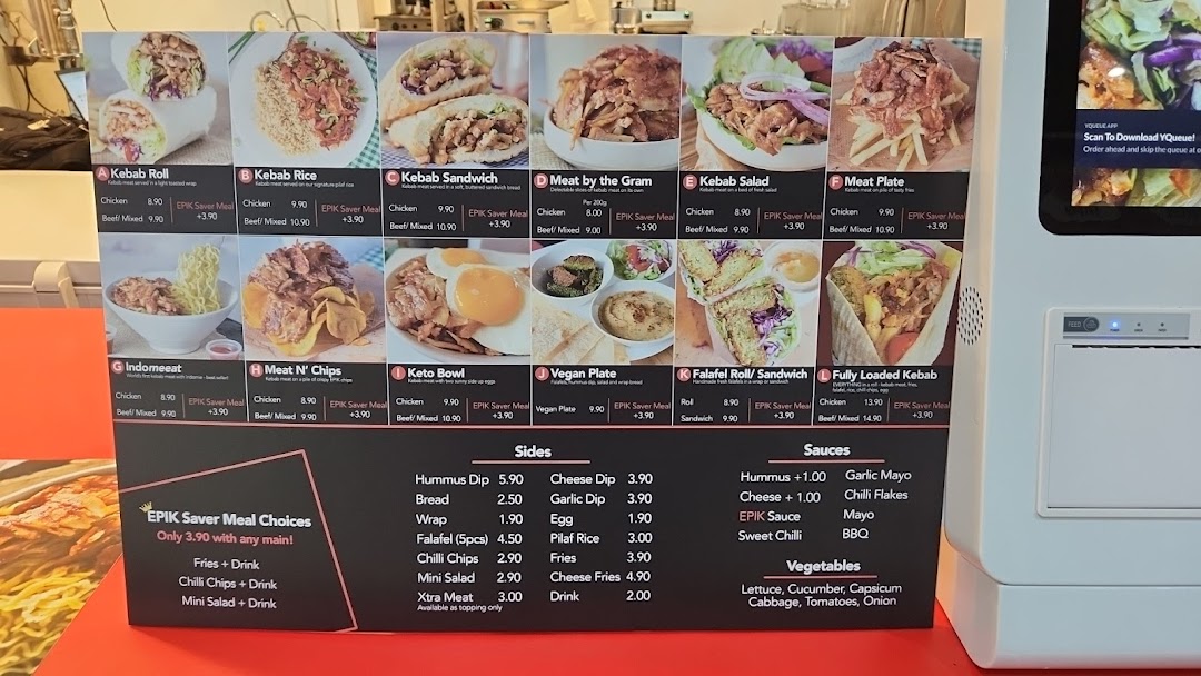 A vibrant menu board displaying various kebab dishes, sides, and sauces with prices and images.