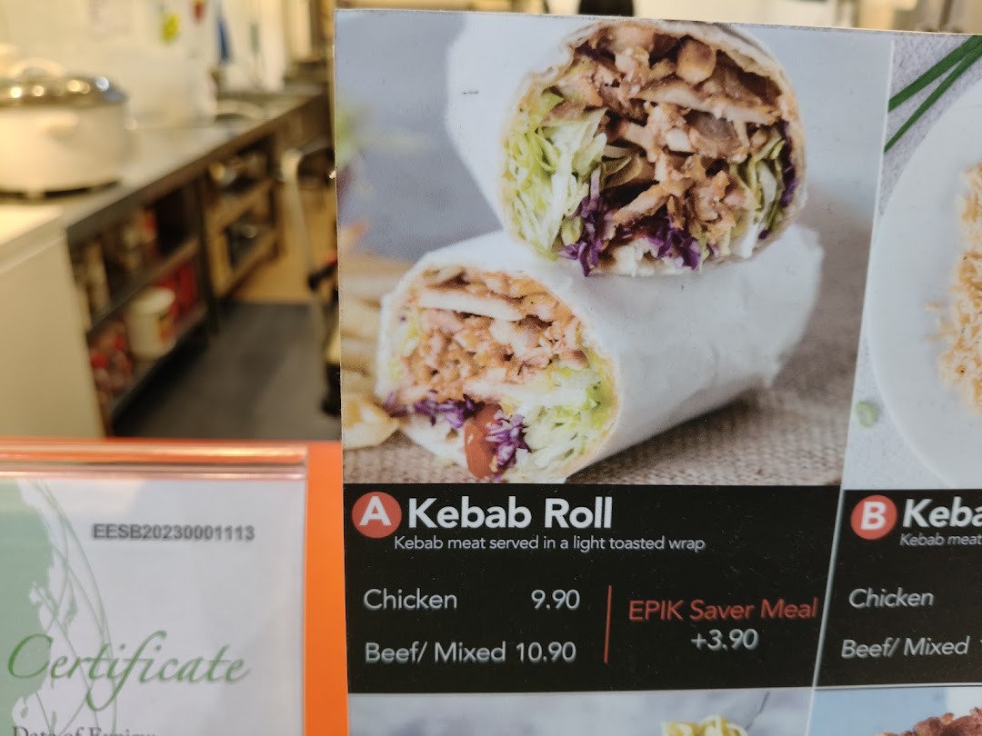 Close-up of a menu board displaying Kebab Roll options with prices and a saver meal offer.