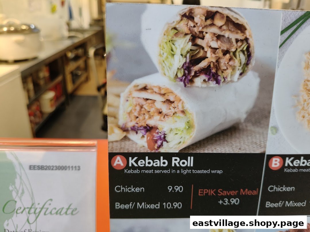 Close-up of a menu board displaying Kebab Roll options with prices and a saver meal offer.