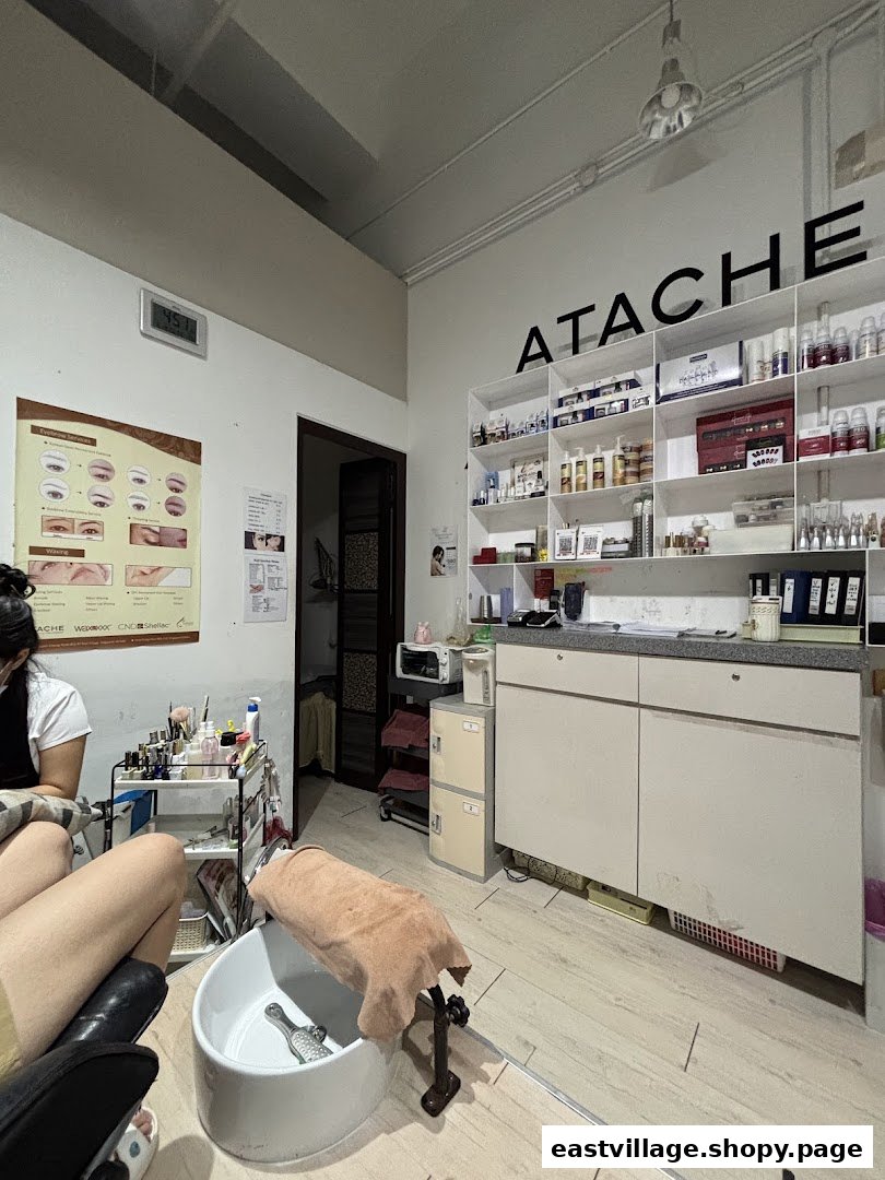 Interior view of Esther Beauty Center showing a pedicure station, product display, and a client.