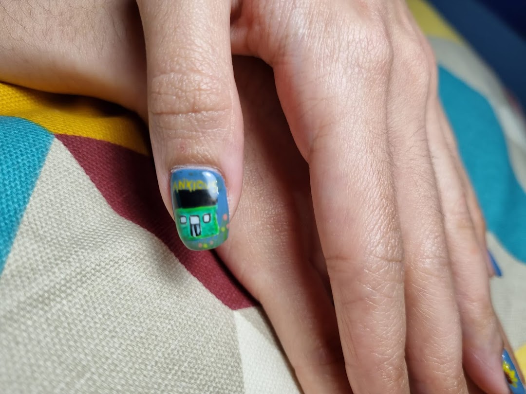 Close-up of a hand showcasing a creative nail art design featuring a green bus on one fingernail.