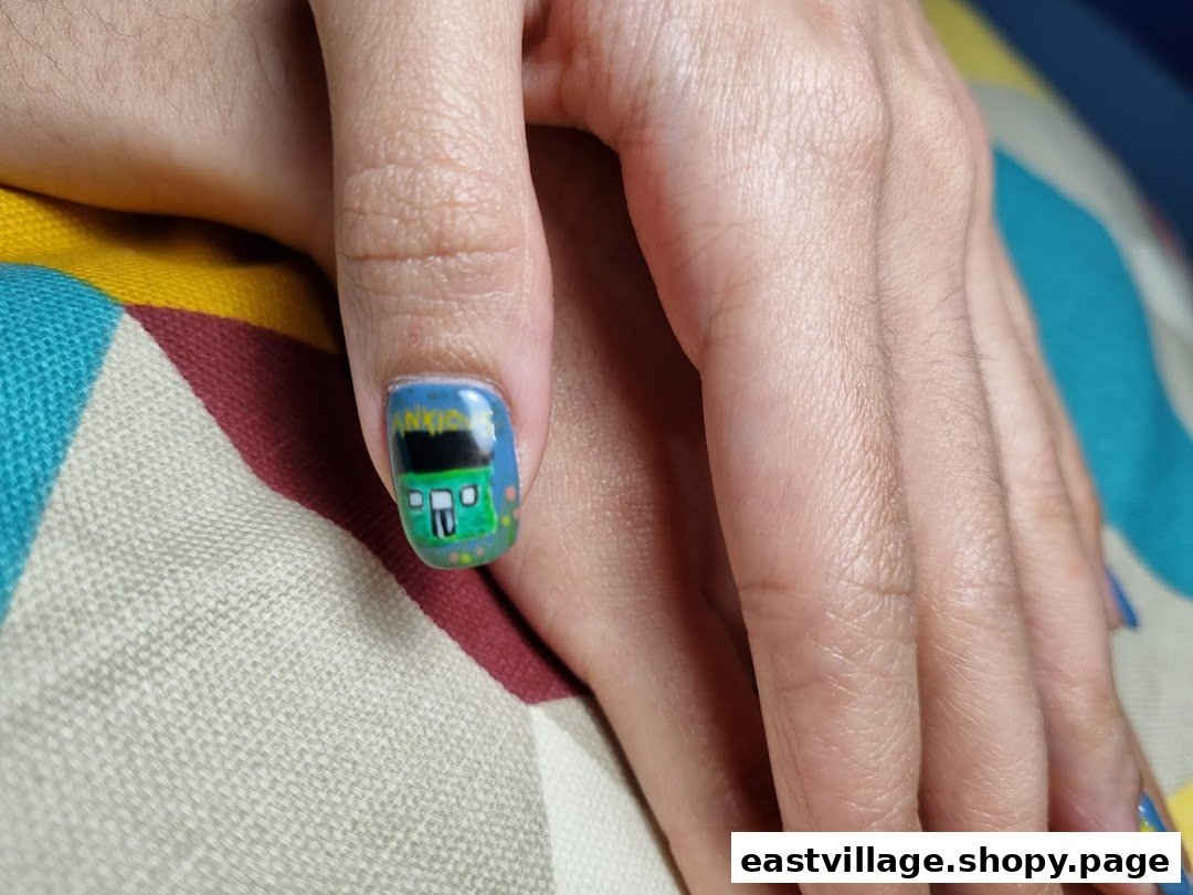 Close-up of a hand showcasing a creative nail art design featuring a green bus on one fingernail.