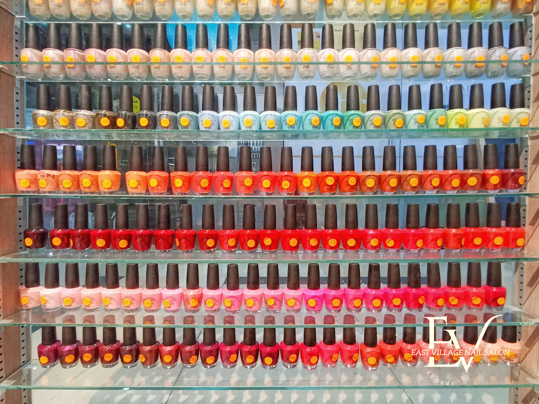 Shelves displaying a vast collection of colorful nail polish bottles in a salon.
