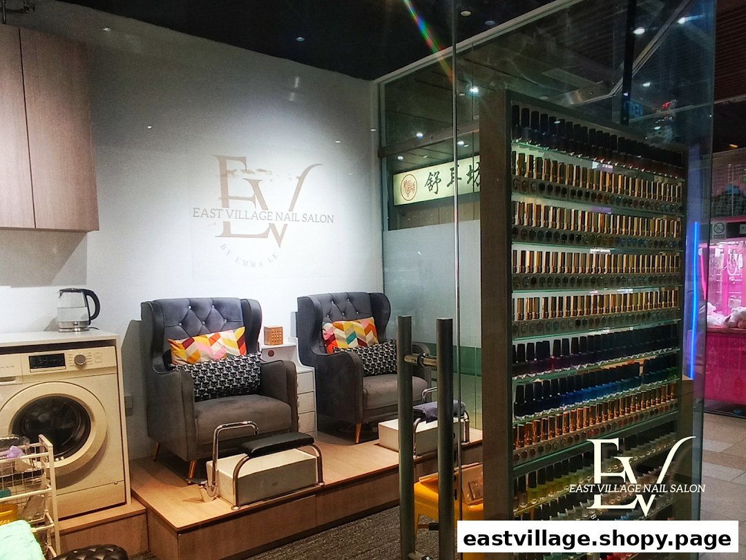 Interior of EV Nail Salon featuring comfortable seating, a washing machine, and a vast display of colorful nail polishes.