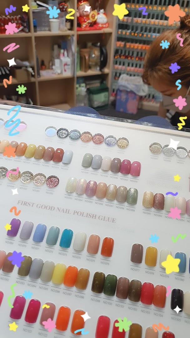 A vibrant display board showcasing a wide variety of nail polish colors and glitter options at a nail salon.
