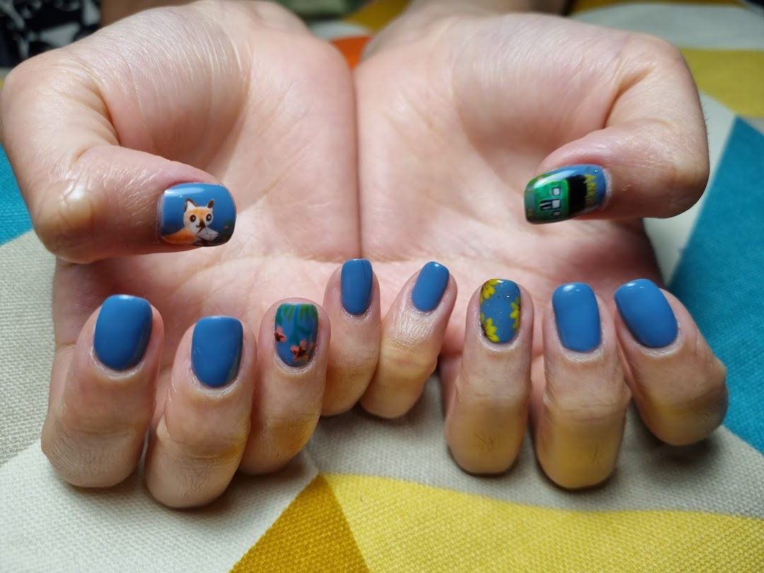 Hands with blue nail polish featuring intricate custom nail art designs, including a fox.