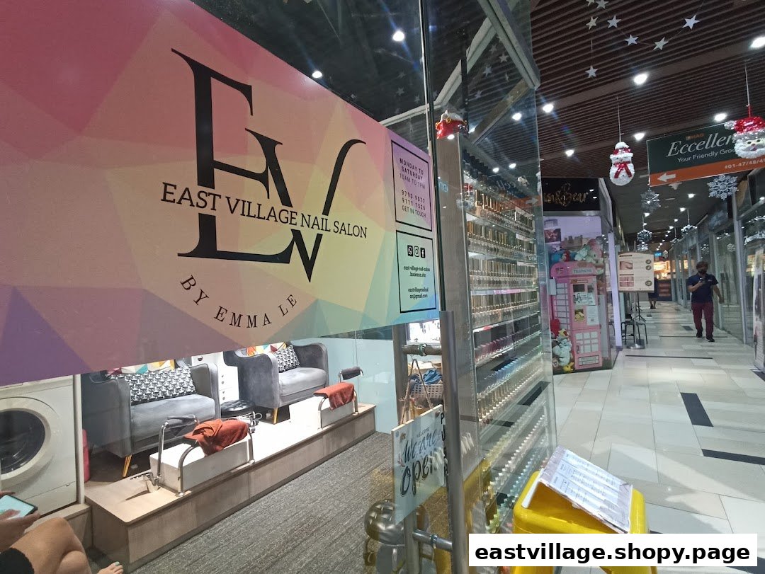 The storefront of EV Nail Salon, showcasing its logo, interior, and inviting entrance.